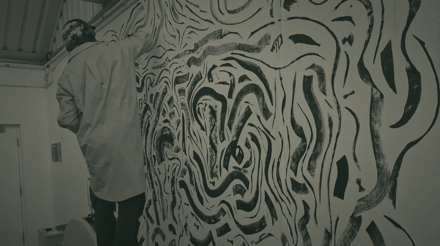 Painting a wall in the studio